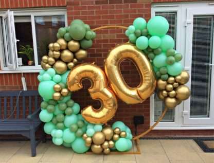 Organic balloon hoop with numbers in green and gold colour scheme. for 30th birthday party