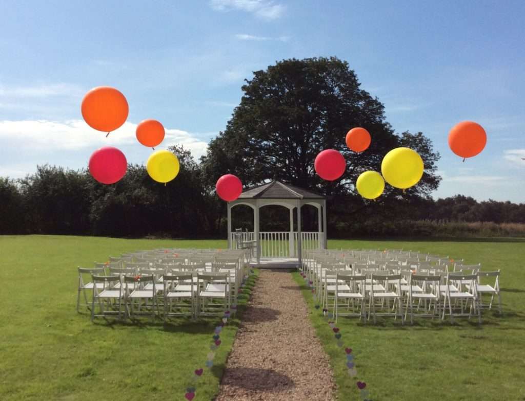 Balloons for outdoor wedding ceremony - Somerford Hall