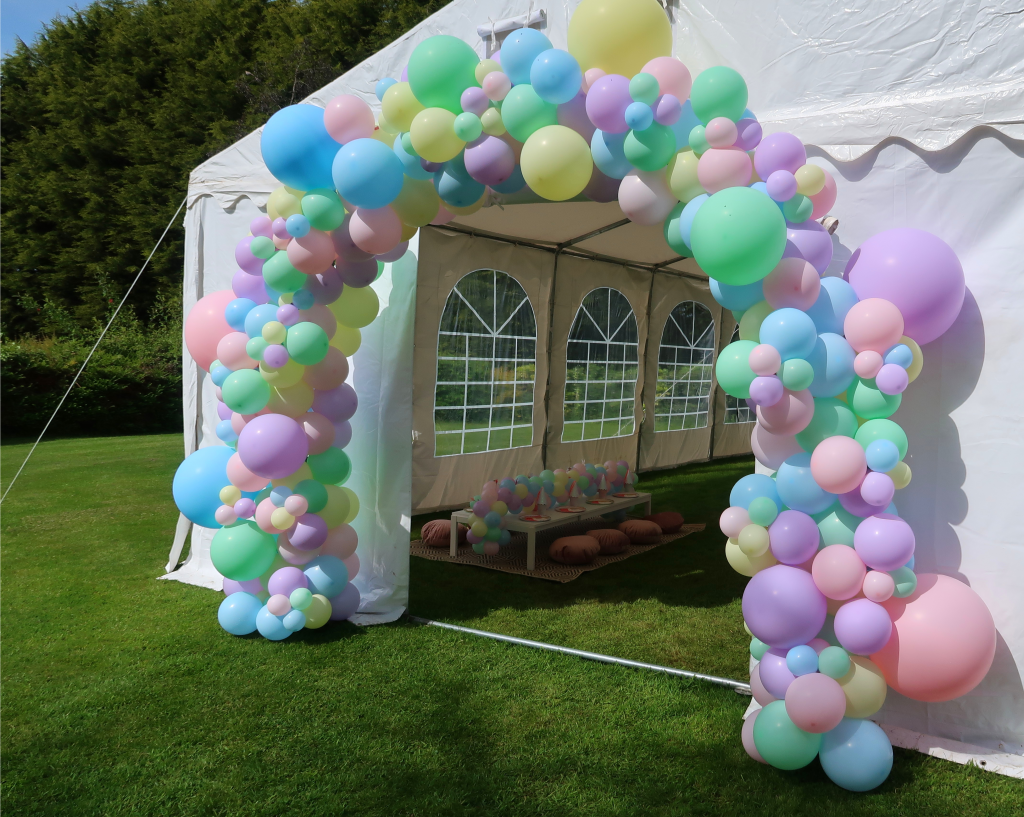 Organic balloon arch in pastel colours for marquee entrance