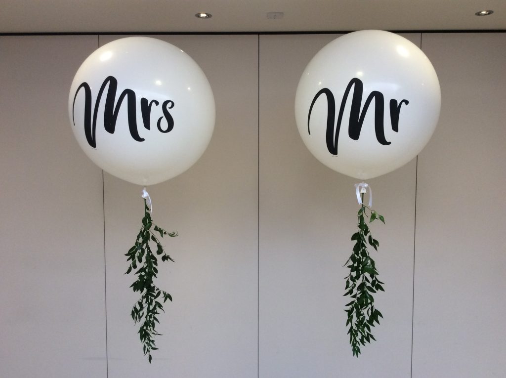 Giant Mr & Mrs balloons with foliage tails